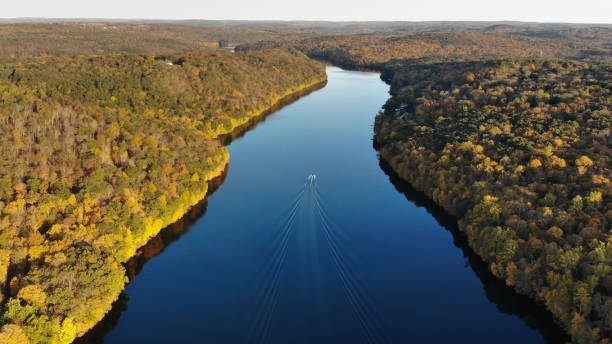 Housatonic River Valley, Lake Lillinoah Litchfield County, Connecticut Drone photo of a calm river. This shot was a lucky take where a Marine Patrol boat passed into frame as I snapped the shot. He was dead middle in the lake and created a patter with his wake in the water. Shot in the fall of 2019. connecticut stock pictures, royalty-free photos & images
