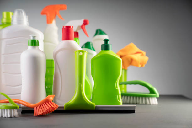House and office cleaning products. White and green cleaning kit on gray background. cleaning products stock pictures, royalty-free photos & images