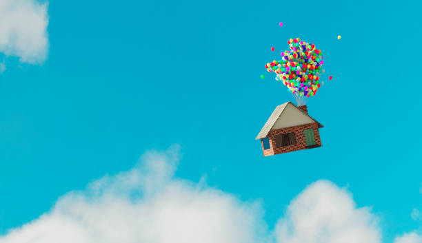 House flys away up in the air thanks to helium balloons Small house flys up in the air after balloons with helium has been attaches to the chimney. moving up photos stock pictures, royalty-free photos & images