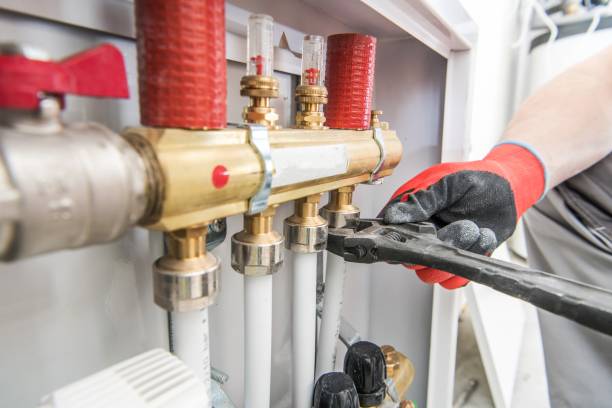 House Heating Valves House Heating Valves and Pipelines Installing by Professional Caucasian Worker. water pipe stock pictures, royalty-free photos & images