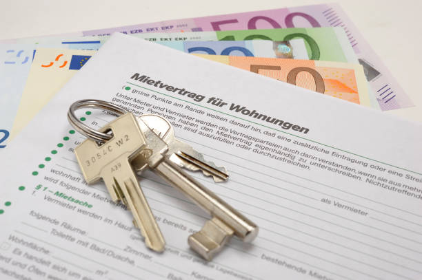 house key and rental contract for apartment - in German language: Mietvertrag für Wohnungen stock photo