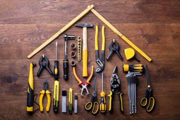 House Made Up Of Measuring Tapes And Tools Elevated View Of Many Tools With Roof Made With Yellow Measuring Tape On Wooden Table work tool stock pictures, royalty-free photos & images