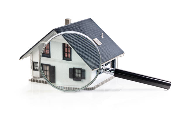 House model with magnifying glass home inspection or searching for a house stock photo