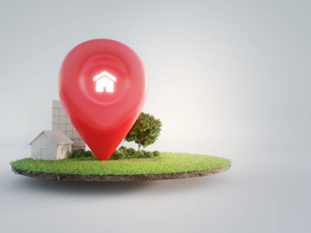 House symbol with location pin icon on earth and green grass in real estate sale or property investment concept. stock photo