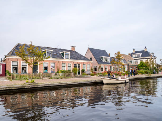 Houses by canal in village of Warten, Leeuwarden, Friesland, Netherlands stock photo