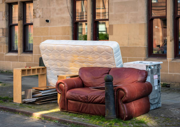 Houshold items left for council uplift A group of discarded household items, including a sofa, mattress and cooker, left on a curbside waiting for the city council to collect them. obsolete stock pictures, royalty-free photos & images