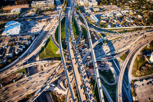 Houston Freeway Interchange Interstates 10 and 610 intersect in Houston, Texas during evening rush hour shot from about 1000 feet overhead. multiple lane highway photos stock pictures, royalty-free photos & images
