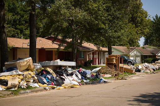 Houston, Texas, USA, September 10, 2017: Consequences from Hurricane Harvey. Flooded, damaged houses on one of the streets. Garbage and damaged things outside the houses.