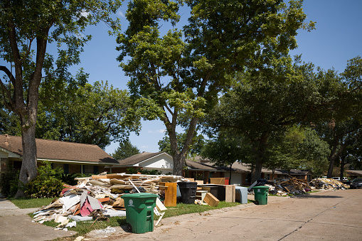 Houston, Texas, USA, September 10 2017: Damaged houses on one of the streets. After hurricane Harvey. Trash and damaged households outside the houses.