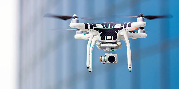 Hovering drone that takes pictures Hovering drone that takes pictures of city sights drone stock pictures, royalty-free photos & images
