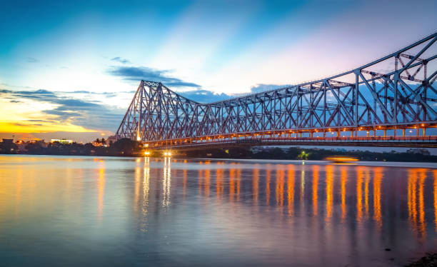 Howrah bridge on river Ganges at Kolkata at twilight with moody sky stock photo