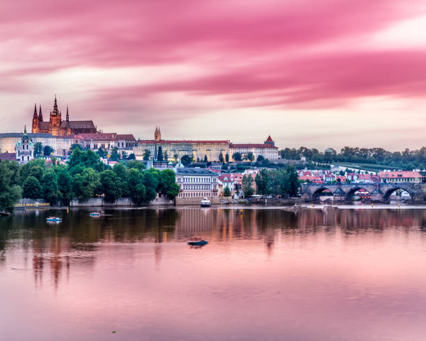 Hradcany Castle and Charles Bridge, illuminated by night This pic shows beautiful view of Prague castle at sunset.The illumintaed view of prague castle is amazing with colorful sky. hradcany castle stock pictures, royalty-free photos & images
