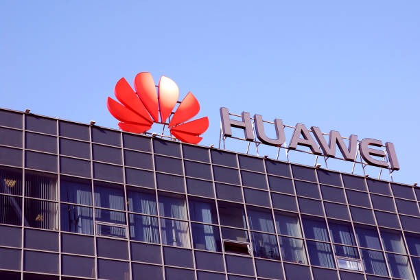 Huawei telecom company logo on office building  against clear blue sky stock photo