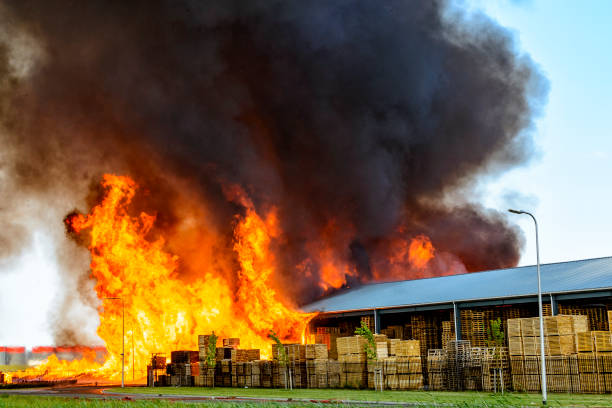 Huge flames from a factory on fire in industrial area stock photo