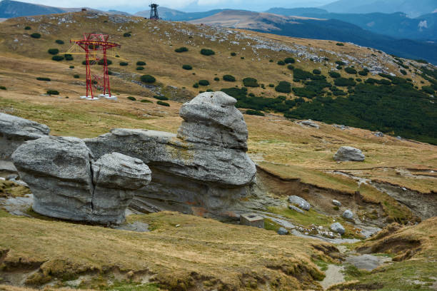 Huge sphinx-like stone in the Bucegi Natural Park in Romania. Megaliths on top of a mountain range, tourist attraction. Huge sphinx-like stone in the Bucegi Natural Park in Romania. Megaliths on top of a mountain range, tourist attraction. bucegi mountains stock pictures, royalty-free photos & images