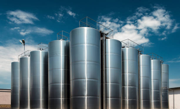 Huge stainless steel wine factory tanks shot outside at daylight stock photo
