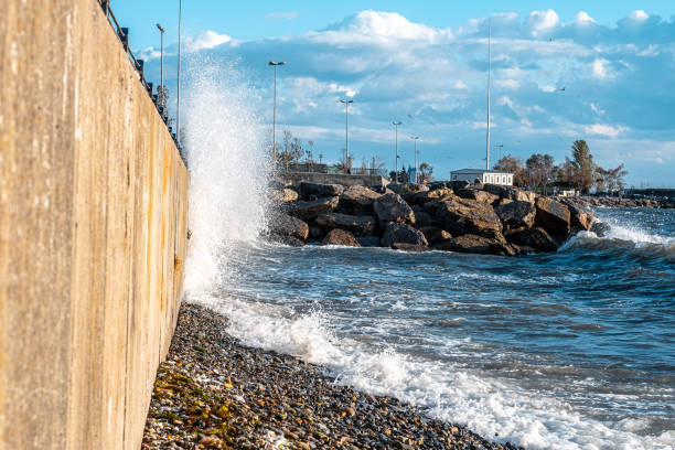 Huge waves crashing over seawall at daytime in Istanbul stock photo