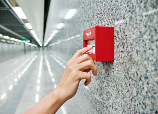 Human finger pushing fire alarm Human finger pushing fire alarm. evacuation stock pictures, royalty-free photos & images