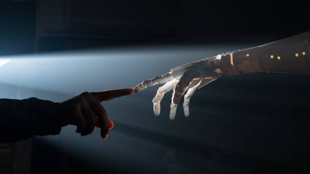 Human Finger Touching Robot Fingers Human finger and robot's finger meet for collaboration between artificial intelligence and human intelligence concept. Back lit is used alongside foggy atmosphere for futuristic feel. Shot with a full frame mirrorless camera. metaverse stock pictures, royalty-free photos & images