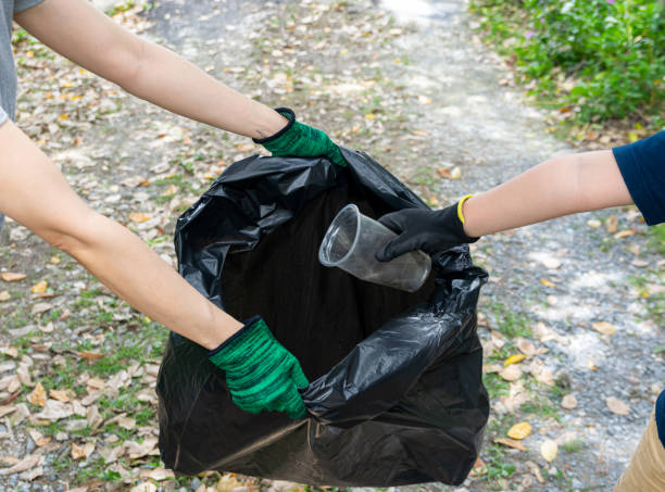 Human hand collect plastic waste in trash bags for the environment"n stock photo