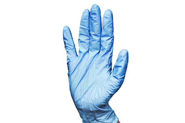 Human right hand in blue rubber medical glove on white background isolated closeup, one surgeon hand in latex protective glove, doctor's hand in glove shows stop gesture, attention sign, safety symbol stock photo
