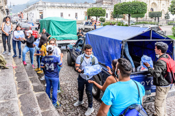 Humanitarian aid after Fuego volcano eruption, Antigua, Guatemala Antigua,, Guatemala -  June 5, 2018:  Volunteers load supplies outside town hall to take to area affected by eruption of Fuego (fire) volcano on June 3. Currently official figures say 121 people died & 300 missing. natural disaster stock pictures, royalty-free photos & images