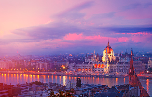 Hungarian Parliament by twilight on the bank of the Danube river