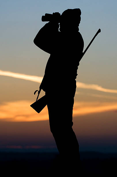 hunter silhouette in sunset stock photo
