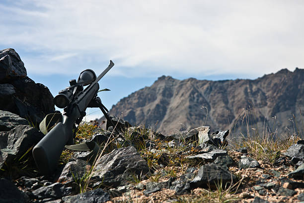 Hunting rifle with  telescopic sight,  bipod while hunting A hunting rifle with a telescopic sight, a bipod while hunting in the Mountains of Tien Shan, Kyrgyzstan tien shan mountains stock pictures, royalty-free photos & images