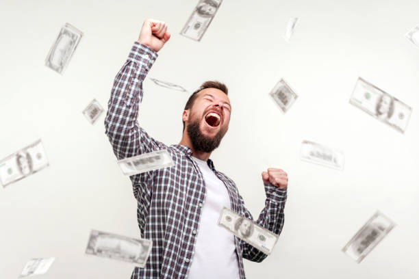 Hurray I am winner and rich now! Portrait of winner man raising hands, screaming yes i did it, joyful reacting to success, victory. money rain falling from up. Hurray I am winner and rich now! Portrait of winner man raising hands, screaming yes i did it, joyful reacting to success, victory. money rain falling from up. indoor, isolated on white background money rain stock pictures, royalty-free photos & images