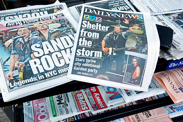 Hurricane Sandy news # 1 XXL "New York City, USA - December 13, 2012: New York Post and Daily News in a newsstand on the street with headlines on the front pages reporting the 121212 Concert for Hurricane Sandy Victims in the sold-out Madison Square Garden." bruce springsteen stock pictures, royalty-free photos & images