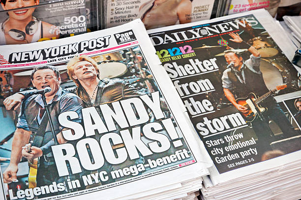 Hurricane Sandy news # 2 XXXL "New York City, USA - December 13, 2012: New York Post and Daily News in a newsstand on the street with headlines on the front pages reporting the 121212 Concert for Hurricane Sandy Victims in the sold-out Madison Square Garden. Bruce Springsteen and Jon Bon Jovi can be seen." new jersey street flooding stock pictures, royalty-free photos & images