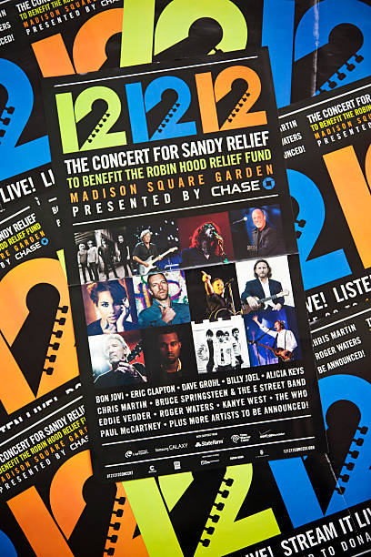 Hurricane Sandy # 4 XXXL "New York City, USA - December 21, 2012: Posters with the announcement of the 121212 Concert for Sandy Relief in Madison Square Garden. These posters were a couple days the cover of the free newspaper AM New York availbale in many street boxes. There were performances by Bon Jovi, Eric Clapton, Bruce Springsteen, Paul McCartney and many other artists." bruce springsteen stock pictures, royalty-free photos & images