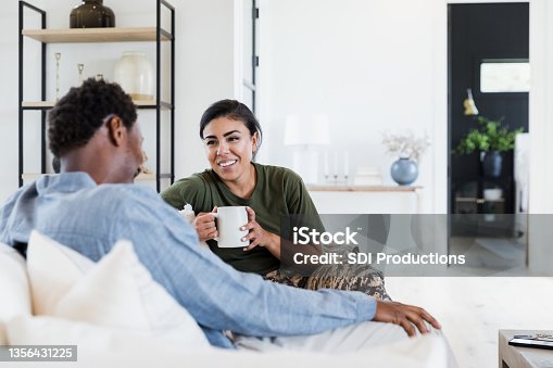 istock Husband and soldier wife bond after her deployment 1356431225