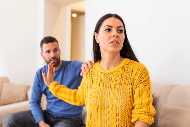 Husband apologizes to wife for treason. Repentant man hope for forgiveness from sad pensive woman. Family on verge of divorce. Couple treason problem concept stock photo