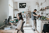 Photo series of interracial married couple working at home in their new home office set-up during lockdown and social distancing.