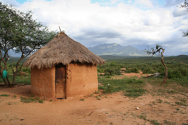 A hut made out of mud in Africa  A mud hut in Kenya, Africa.  The background has a beautiful mountain in it, with immersive, interesting lighting due to the oncoming storm.  The door of the hut has a cheap padlock on it, making for a potentially interesting metaphor.   hut stock pictures, royalty-free photos & images