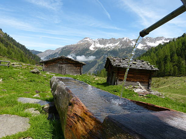Huts with wooden well Huts with wooden well lechtal alps stock pictures, royalty-free photos & images