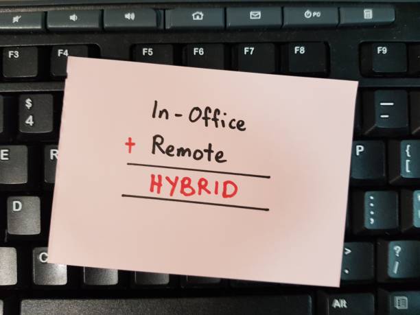 Hybrid work model has employees working both in-office and home or remotely stock photo