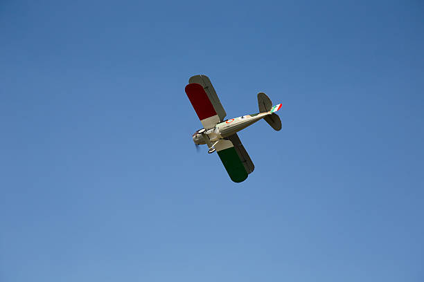 Hystorical Biplane flying on blue Sky stock photo