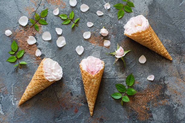 Waffle cones with roses, overhead composition with flowers, petals,...