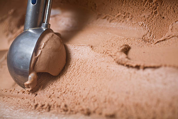 Ice cream spoon scooping chocolate icecream stock photo