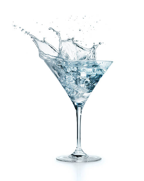Ice cube splashing in Martini Ice cube splashing in Martini on white background  More like this dirty martini stock pictures, royalty-free photos & images
