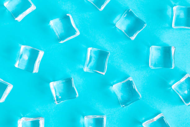 Ice cubes pattern isolated on blue refreshment abstract. stock photo