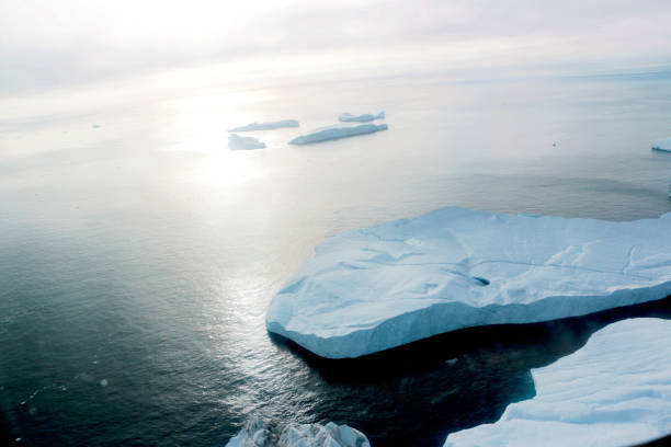 iceberg in a sunset fjord from a Aerial view, in greenland stock photo