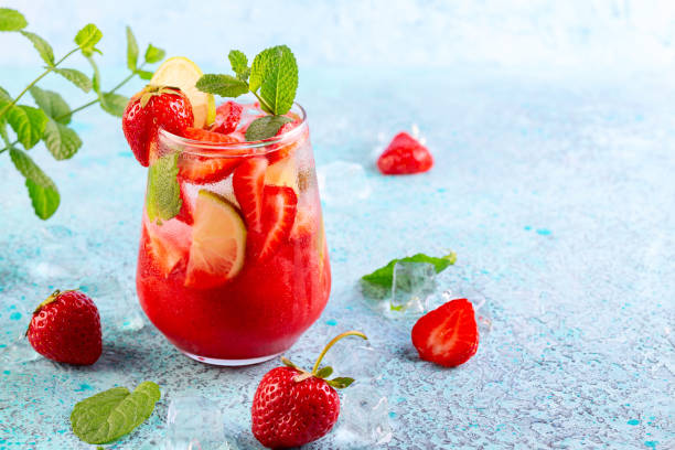 Ice-cold strawberry drink with lime. stock photo