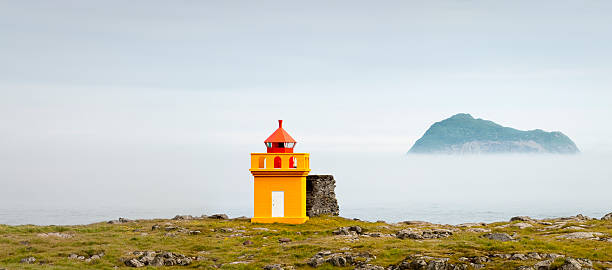 Iceland, lighthouse and fog landscape stock photo