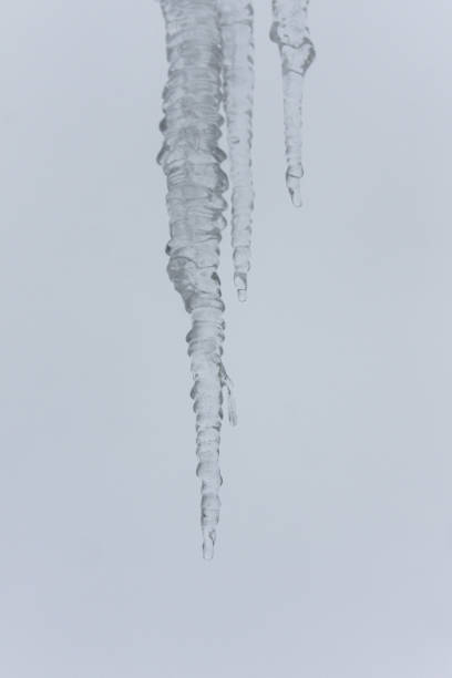 icicle hanging from roof melting stock photo
