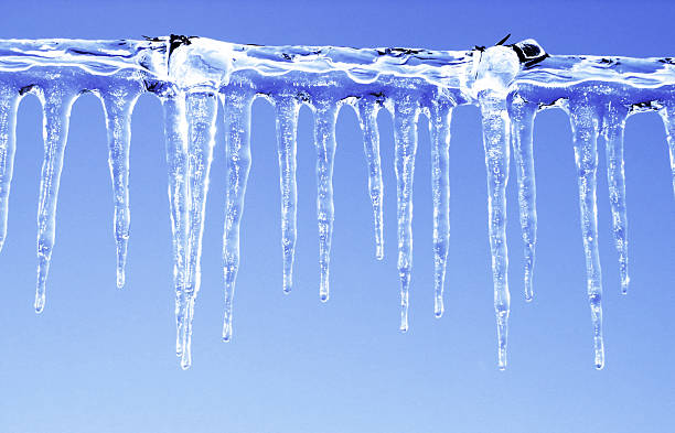 Icicles on a barbed wire outside stock photo