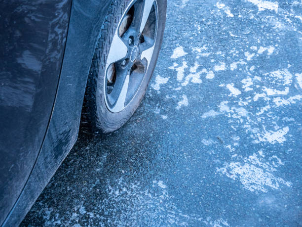 icy road surface in winter black ice, black ice stock photo